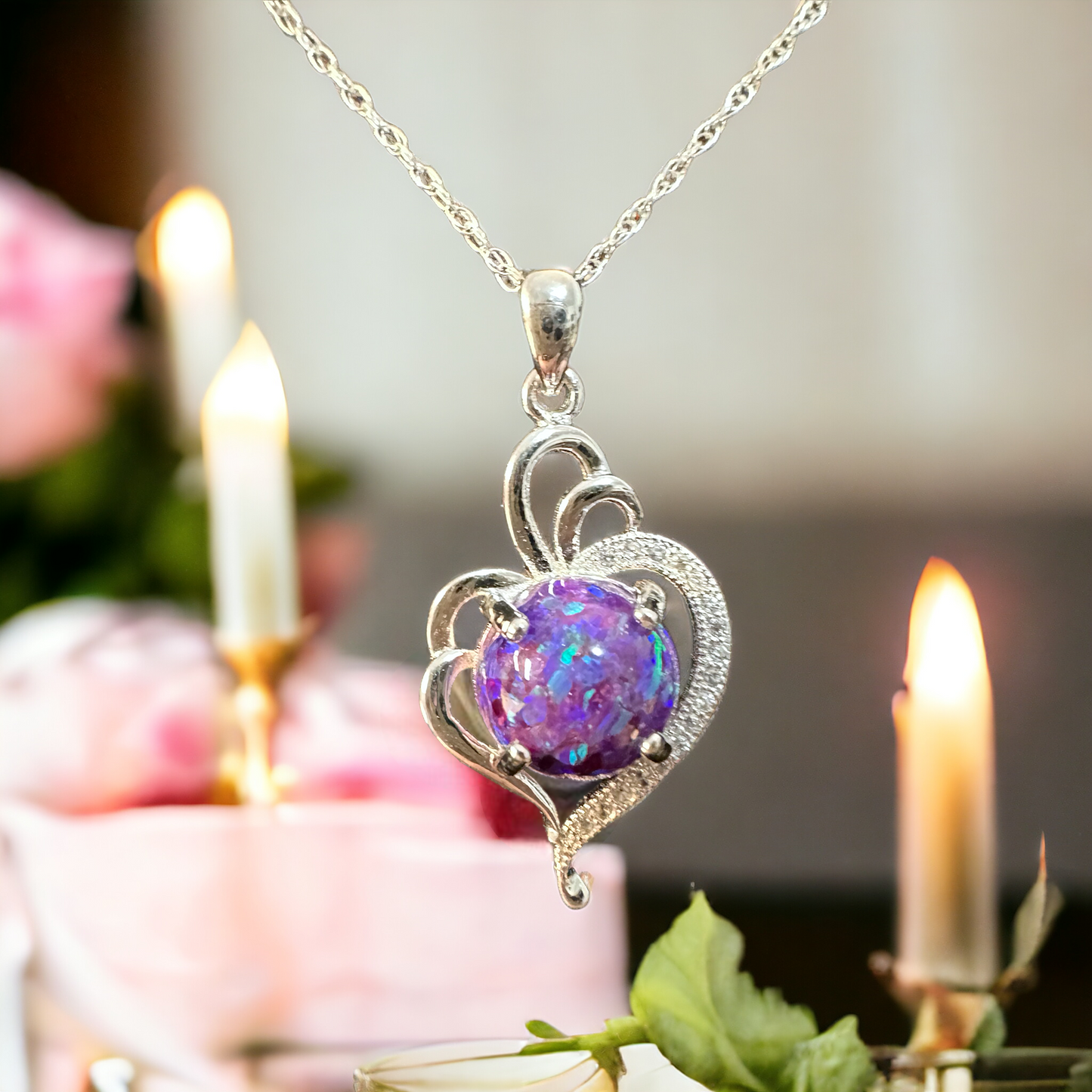 Closeup of Radiant Heart sterling silver pendant hanging by the chain, featuring a heart-shaped sparkly purple crushed opal cremation stone, symbolizing eternal love and remembrance.