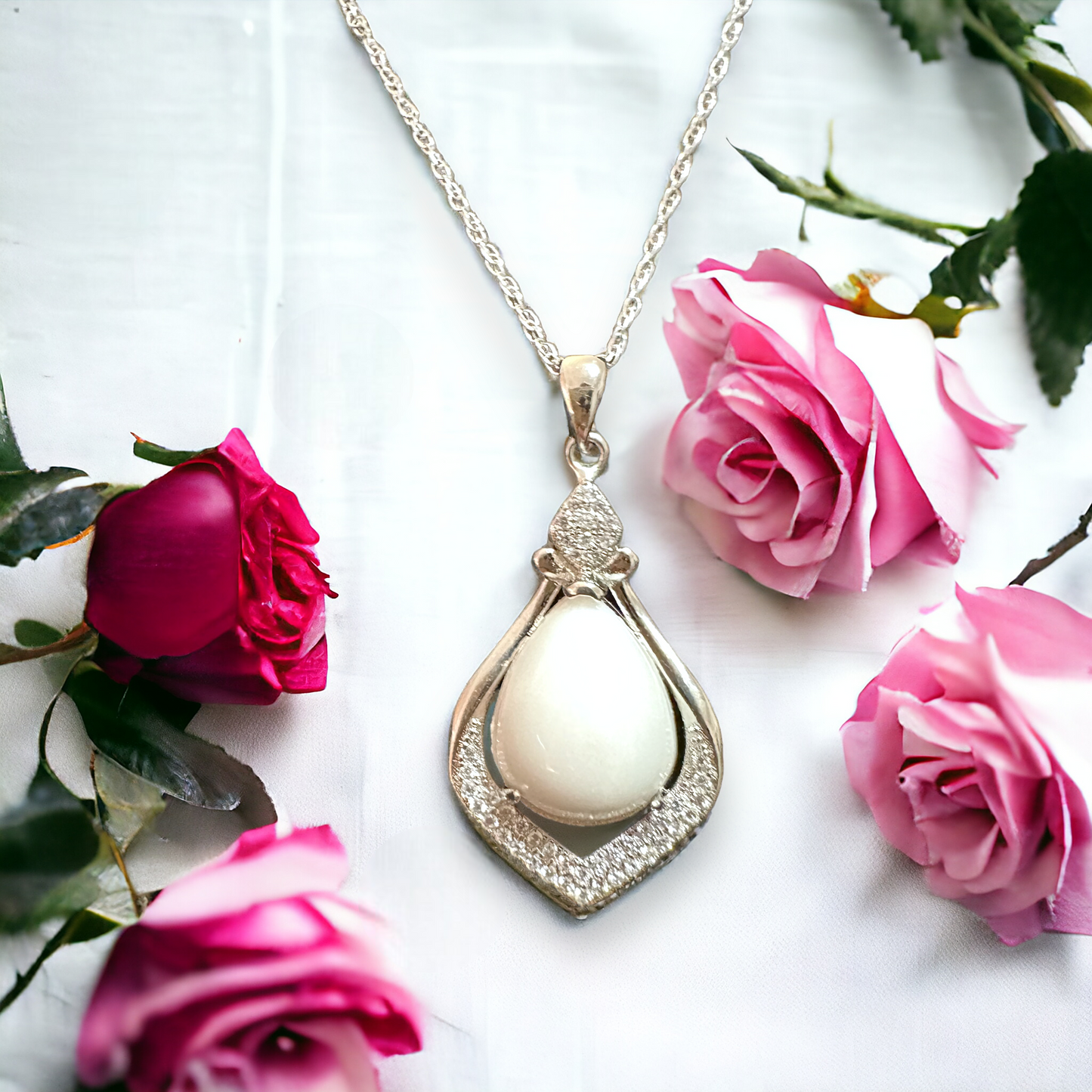 Close-up of Crystal Drop necklace featuring a pear-shaped white breastmilk stone set in sterling silver, symbolizing the precious bond and memories encapsulated in this elegant piece of jewelry.