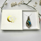 Rainbow Labradorite Necklace in Sterling Silver Floral Setting shown in white gift box with golden logo