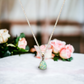 Closeup of Whisper Drop sterling silver necklace hanging, featuring a pear-shaped seafoam crushed crystal cremation stone, elegantly capturing the essence of remembrance and love.