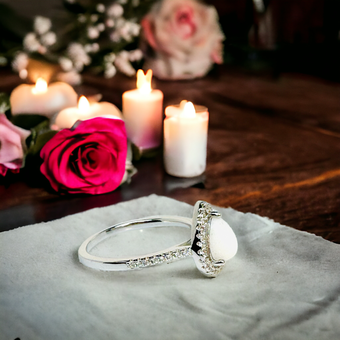 Side view of Precious Drop Halo Pear Ring in Sterling Silver, highlighting the luminous white breastmilk stone set in a halo of cz stones, capturing the essence of maternal bond and memory.