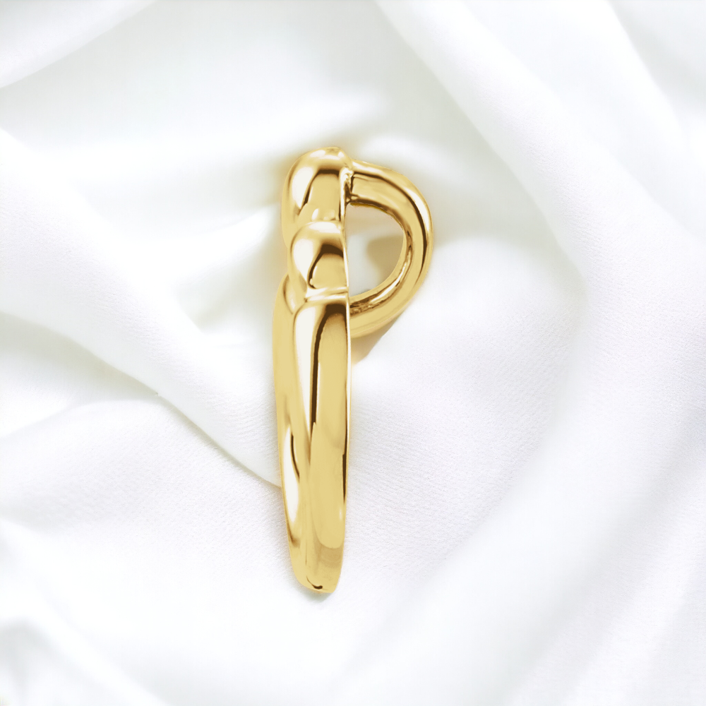 14K yellow gold Mother and Child Embrace Pendant, side view on plush fabric.