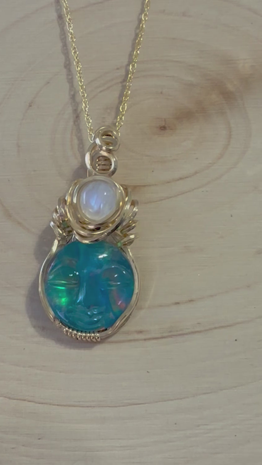 Video showcasing the Luminous Moonlight Aurora Opal and Moonstone Necklace, highlighting the vibrant colors and detailed carving of the opal triplet. The movement captures the light playing off the moonstone and aurora opal layers, emphasizing the necklace's ethereal beauty.