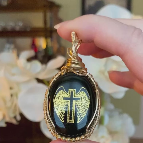 Video of Hardest Goodbye winged cross memorial necklace featuring front and back designs.