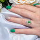 Emerald green cremation ash stone example in a wishbone cremation ring set, on a hand model. Available in 14k gold or sterling silver. Perfect for breastmilk or cremation ash. 