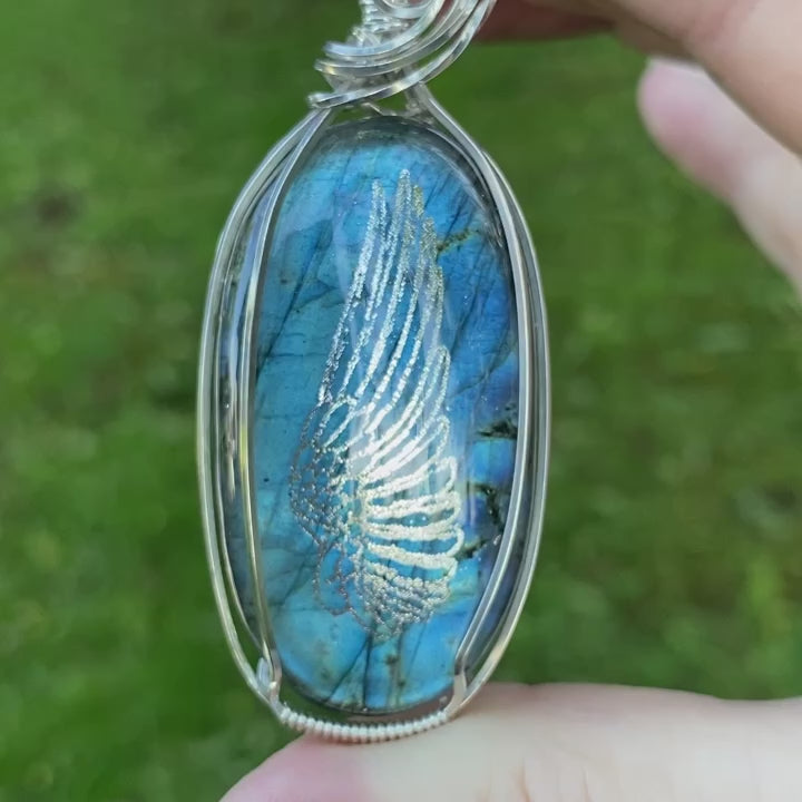 Video showcasing the beautiful front design of the Mom Angel necklace featuring a Labradorite gemstone and angel wing design on a Sterling Silver setting.